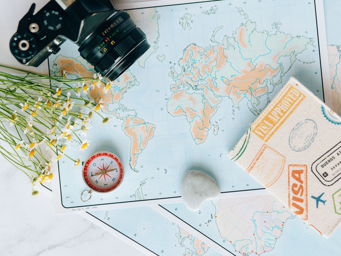 A passport and a boarding pass on a desk